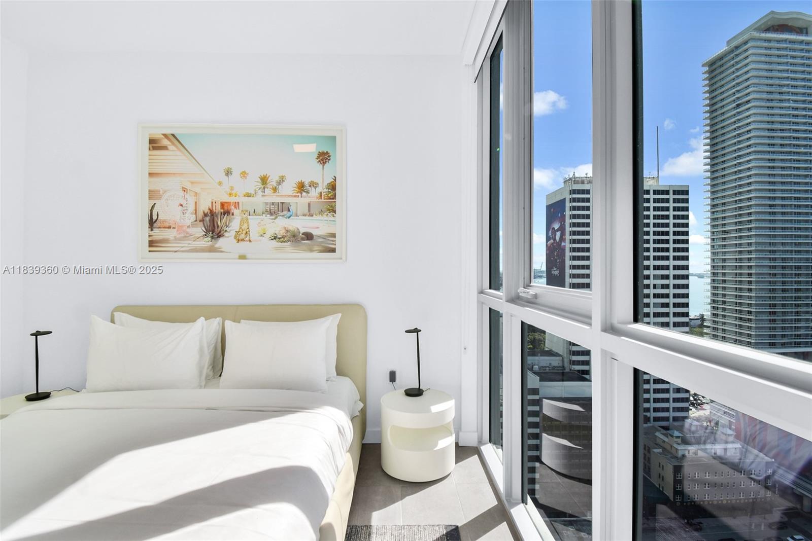 227 Northeast 2nd Street, Unit 2000 Miami, FL 33132 - Photo 25 of 44 a bedroom with a bed and a painting on the wall