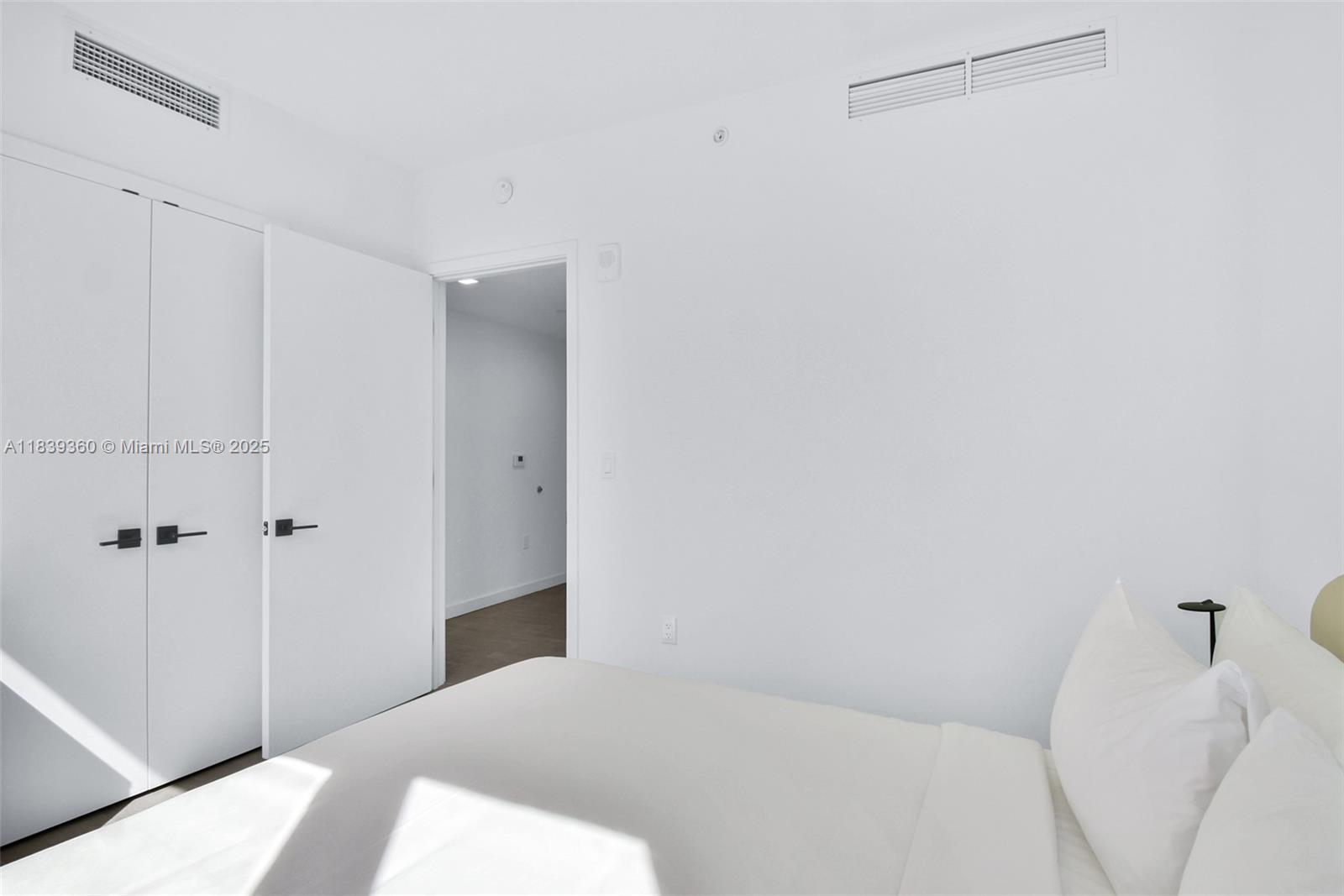 227 Northeast 2nd Street, Unit 2000 Miami, FL 33132 - Photo 26 of 44 a bedroom with a bed and a shower