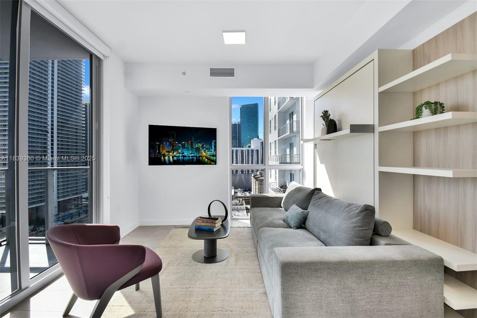 227 Northeast 2nd Street, Unit 2000 Miami, FL 33132 - Photo 3 of 44 a living room with furniture and a flat screen tv