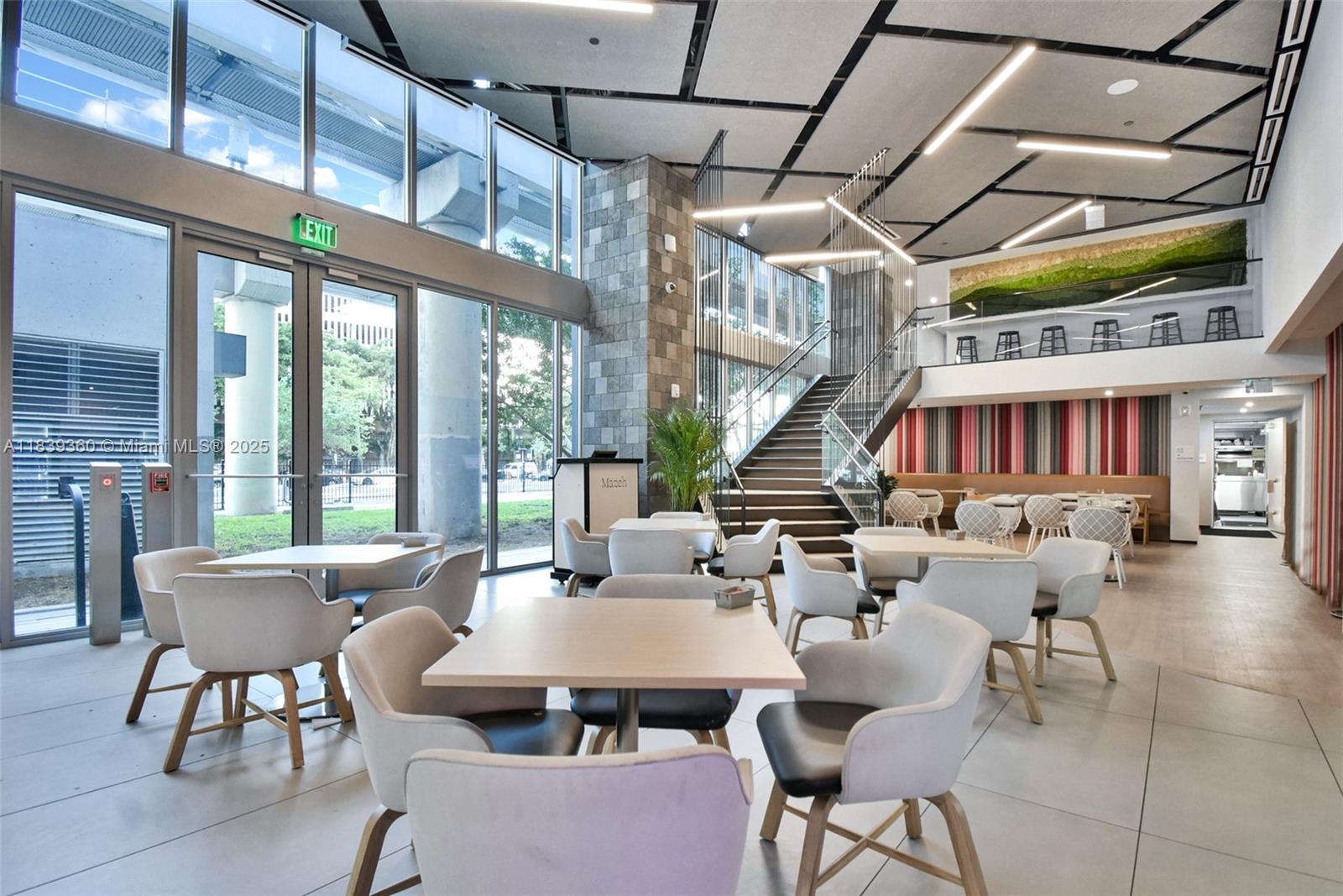 227 Northeast 2nd Street, Unit 2000 Miami, FL 33132 - Photo 35 of 44 a outdoor space with lots of tables a large window and chairs