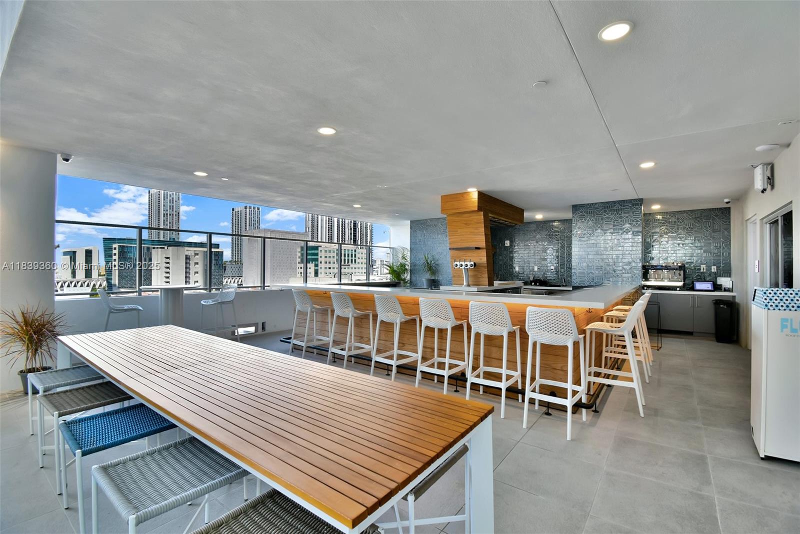 227 Northeast 2nd Street, Unit 2000 Miami, FL 33132 - Photo 41 of 44 a large swimming pool with a table and chairs