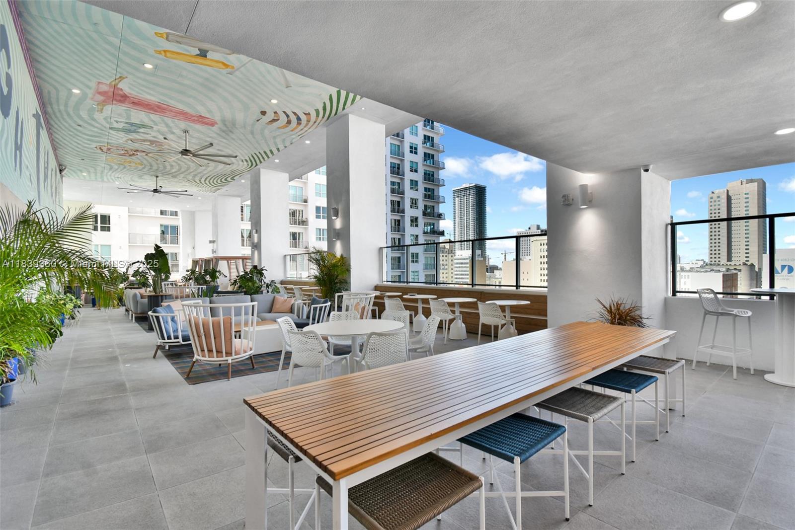 227 Northeast 2nd Street, Unit 2000 Miami, FL 33132 - Photo 42 of 44 a dining room with wooden floor and large windows