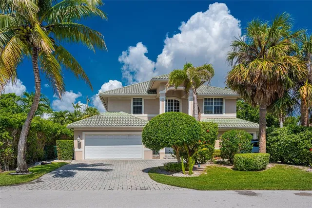 a front view of a house with a yard garage and outdoor seating