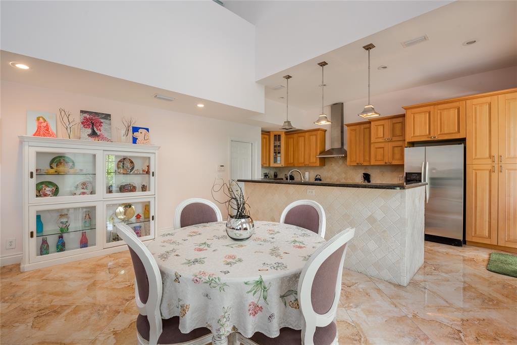 2999 Banyan Road Boca Raton, FL 33432 - Photo 11 of 38 a dining table with chairs and cabinets