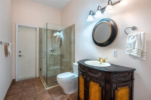 a bathroom with a toilet a sink and a mirror