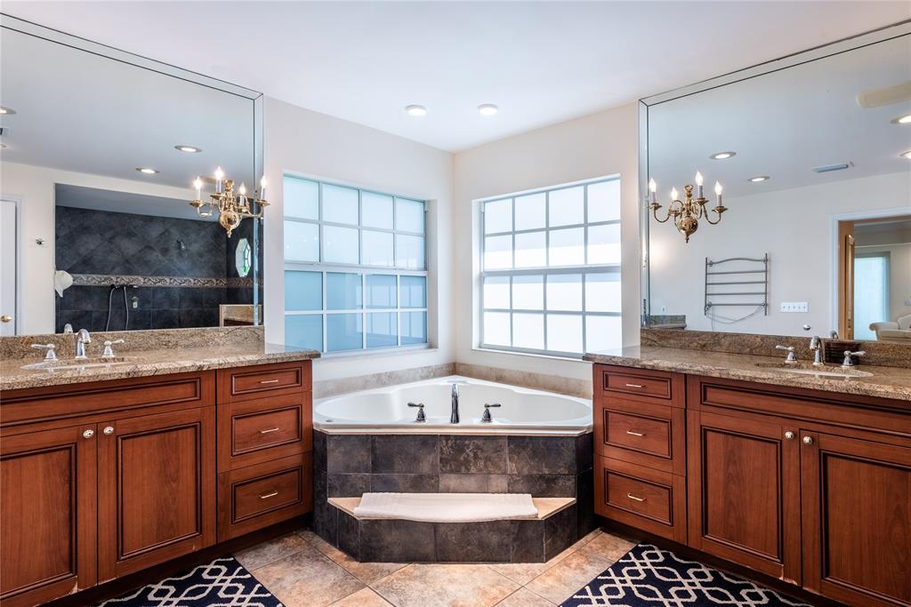 2999 Banyan Road Boca Raton, FL 33432 - Photo 19 of 38 a spacious bathroom with a tub a double vanity sink and a large mirror