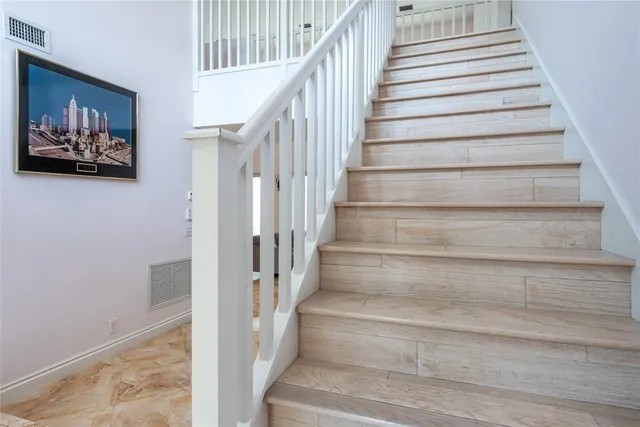 a view of staircase with white walls and a window