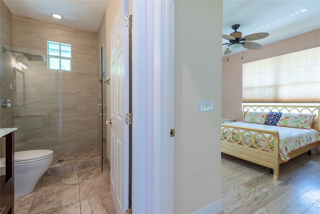 2999 Banyan Road Boca Raton, FL 33432 - Photo 23 of 38 a en suite bathroom with a granite countertop sink a toilet and shower