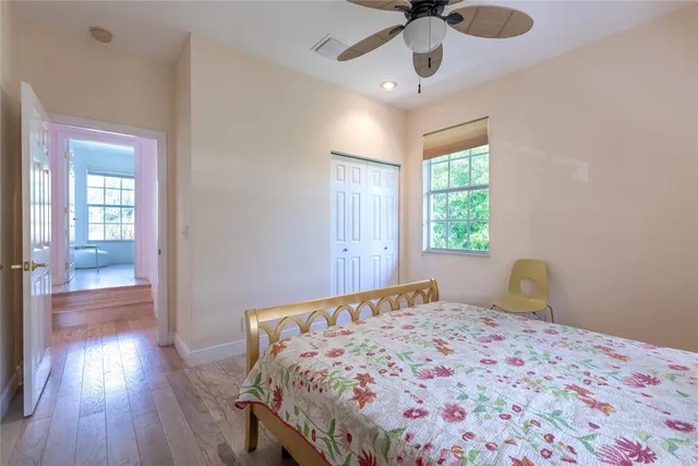 a bedroom with a bed and wooden floor