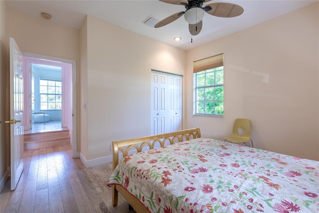 2999 Banyan Road Boca Raton, FL 33432 - Photo 26 of 38 a bedroom with a bed and wooden floor