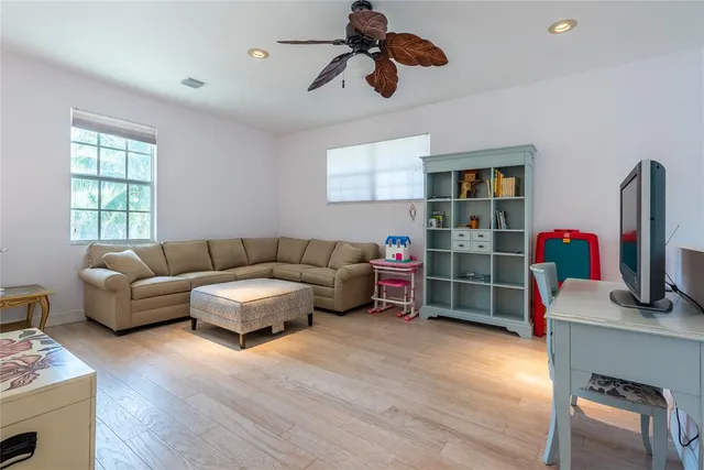 a living room with furniture a air conditioner and a window
