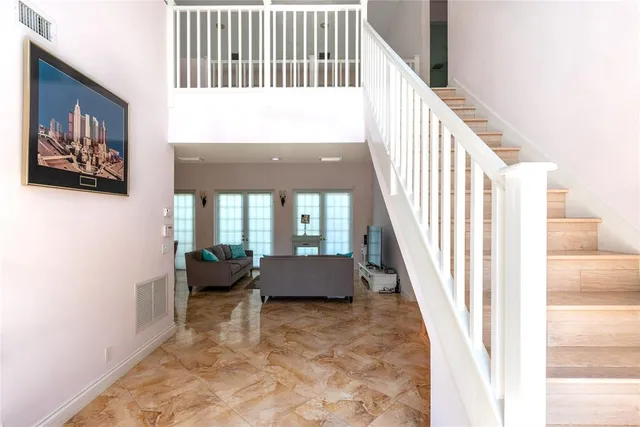 a view of staircase with furniture and a window