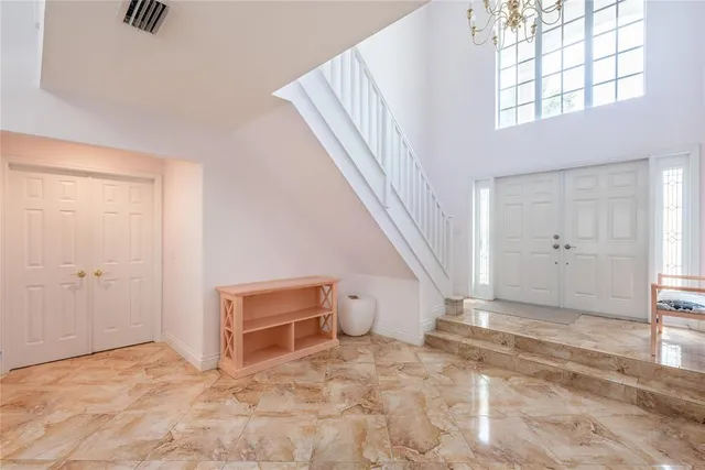 a view of a livingroom with wooden floor and stairs
