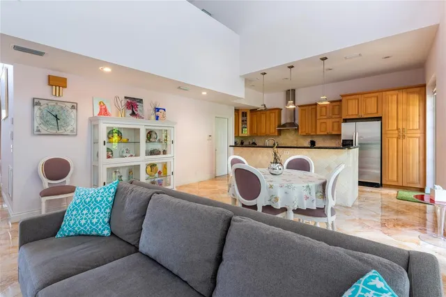 a living room filled with furniture and a large window
