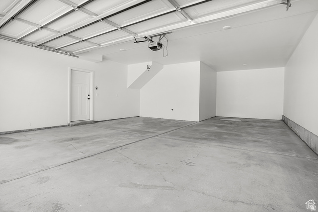 1631 West Century Lane, Unit C Mapleton, UT 84664 - Photo 28 of 31 Spacious garage featuring a concrete floor, painted white walls, and an overhead garage door mechanism