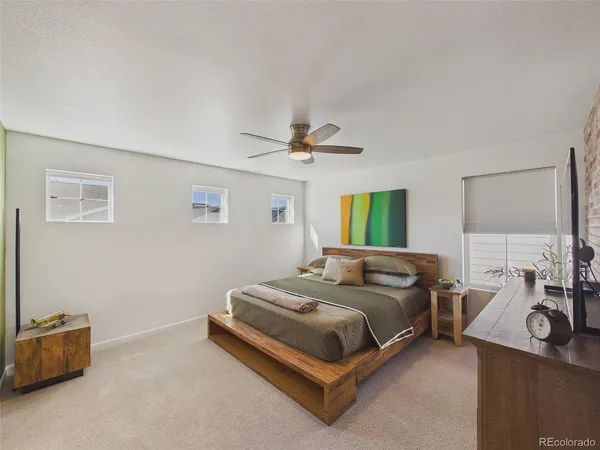 a bedroom with a bed and a couch