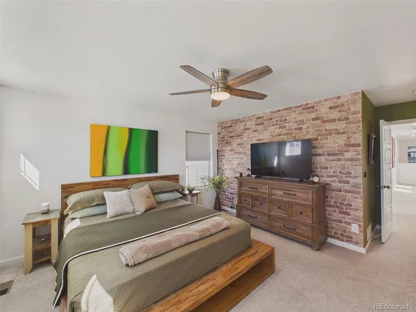 a bedroom with a bed and a television