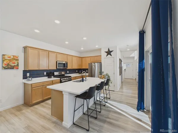 a kitchen with a table chairs and a refrigerator