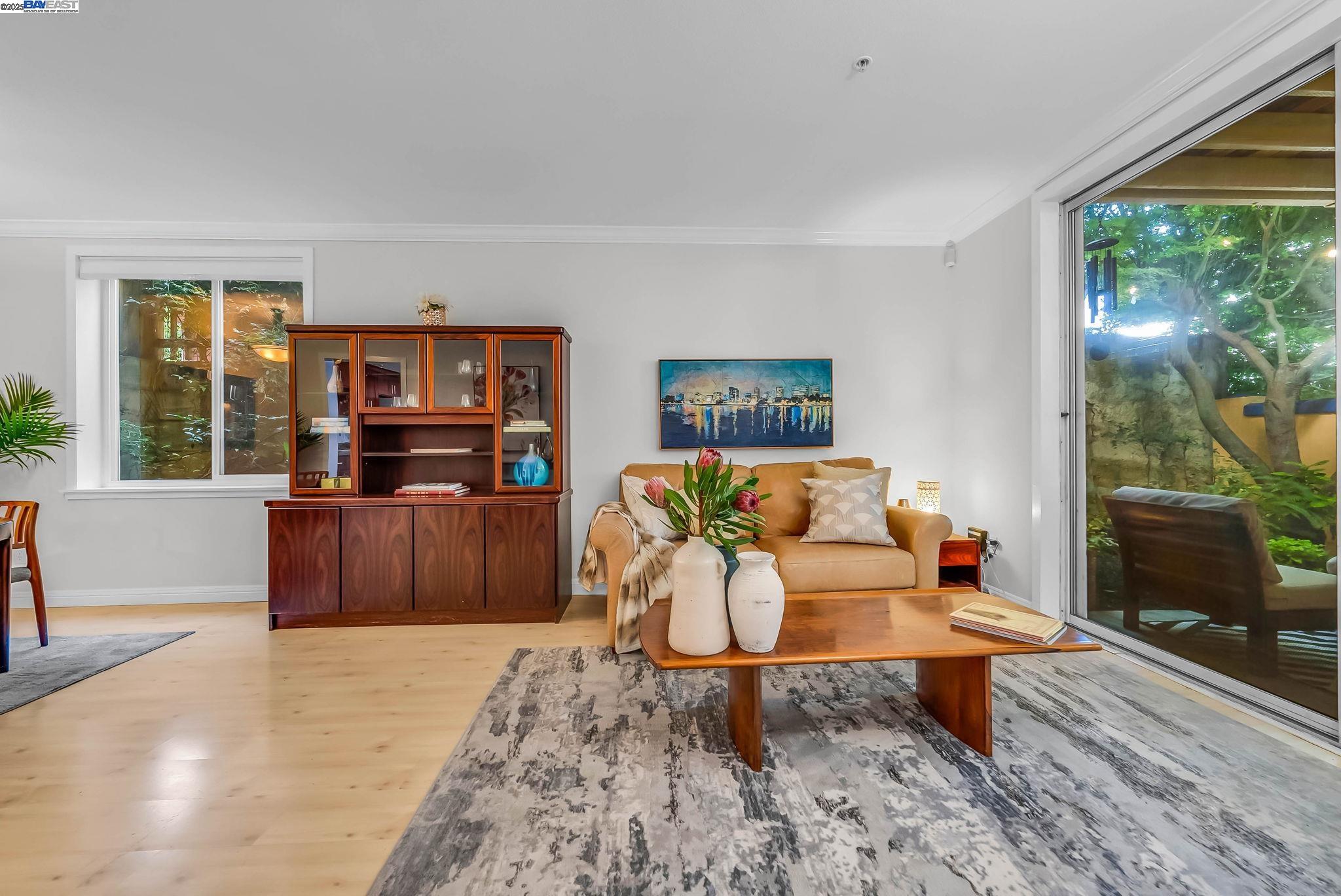 400 Wayne Avenue, Unit 1 Oakland, CA 94606 - Photo 11 of 37 a living room with furniture and a flat screen tv