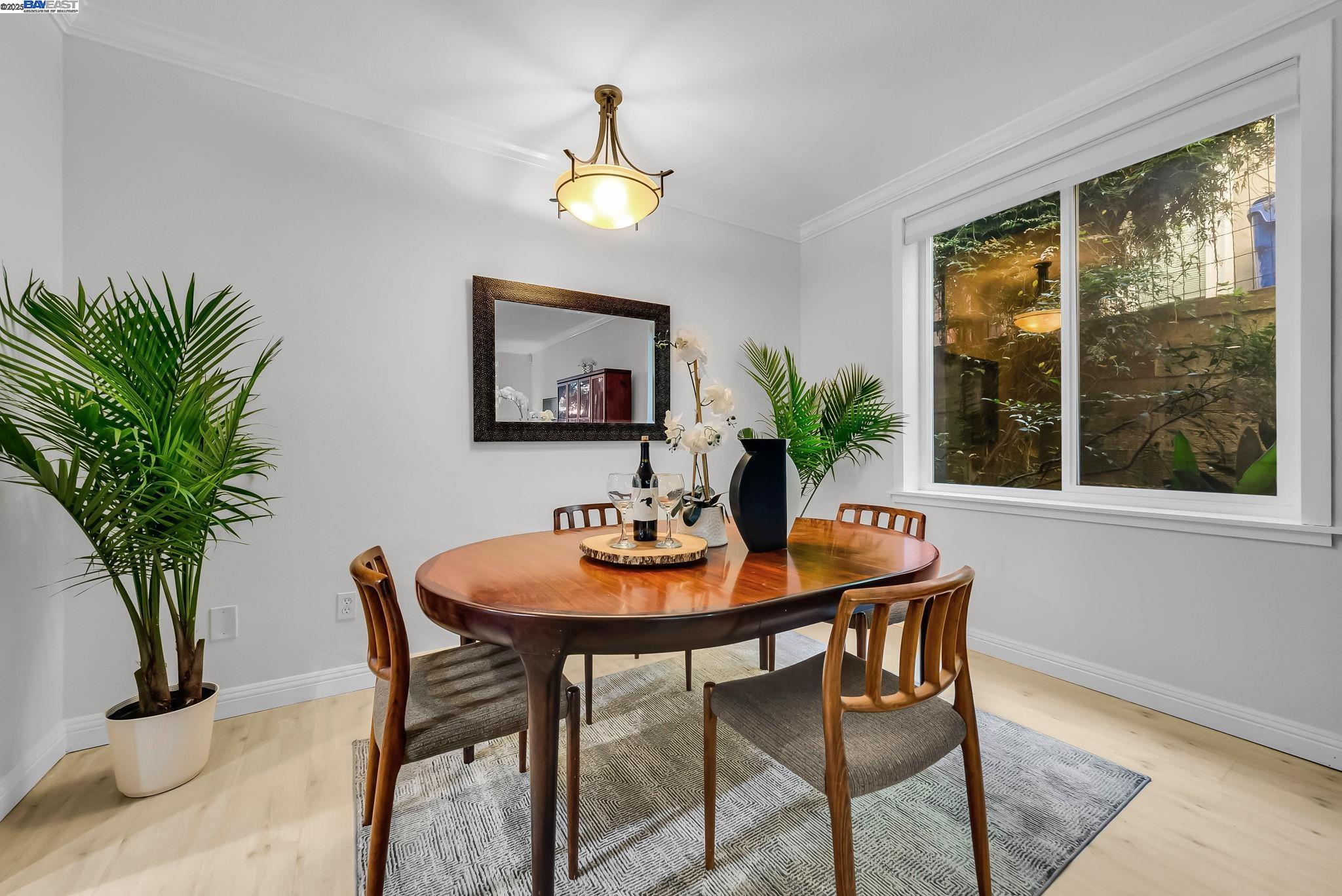 400 Wayne Avenue, Unit 1 Oakland, CA 94606 - Photo 15 of 37 a view of a dining room with furniture and a potted plant