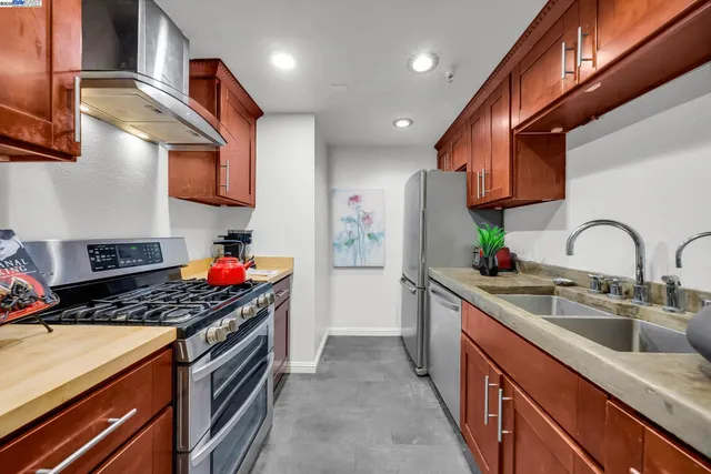 a kitchen with granite countertop stainless steel appliances and wooden cabinets