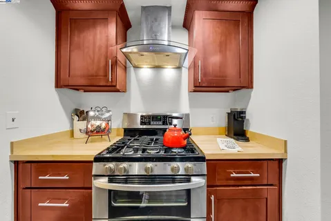a kitchen with stainless steel appliances granite countertop a sink and a refrigerator