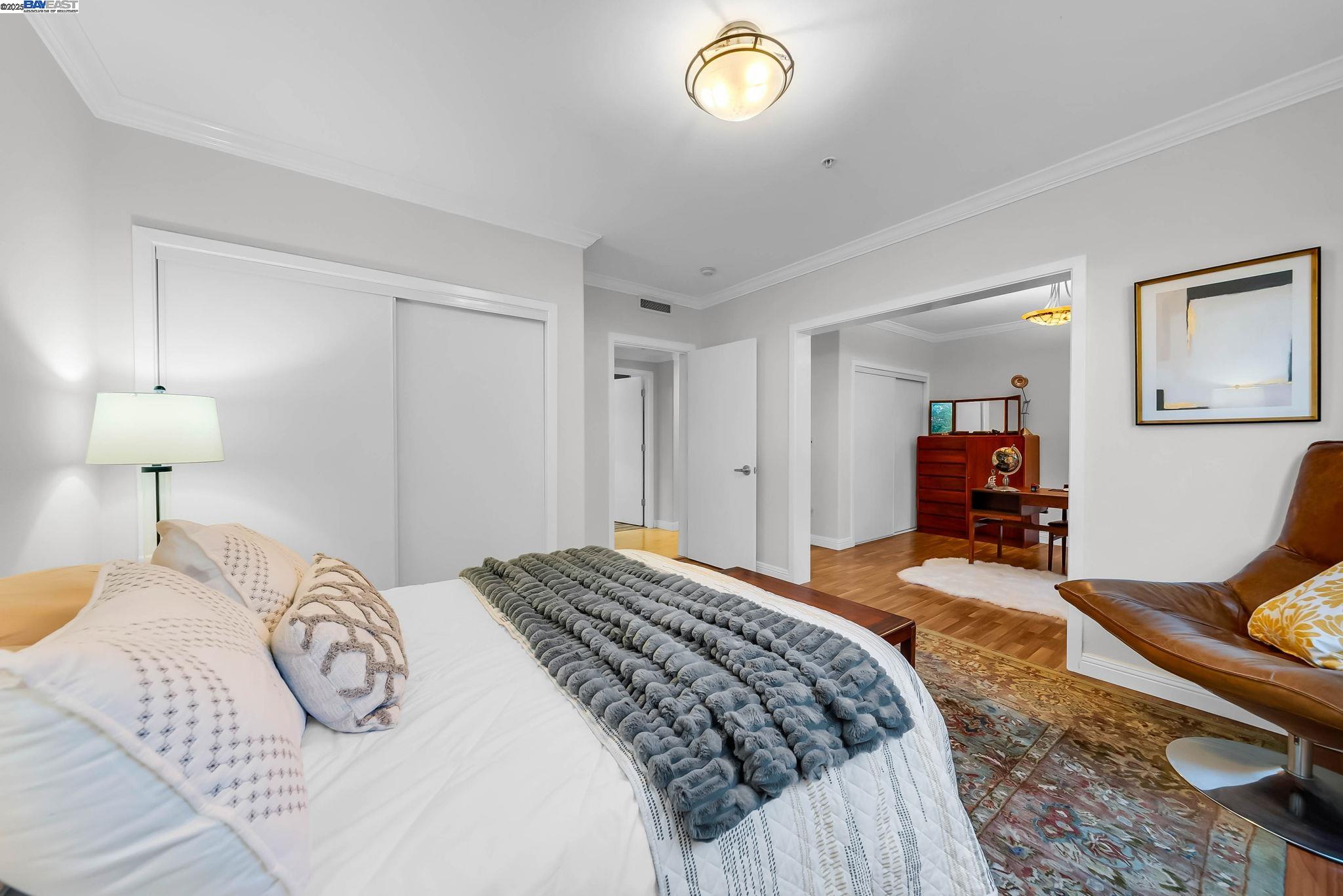 400 Wayne Avenue, Unit 1 Oakland, CA 94606 - Photo 26 of 37 a bedroom with a bed and a lamp