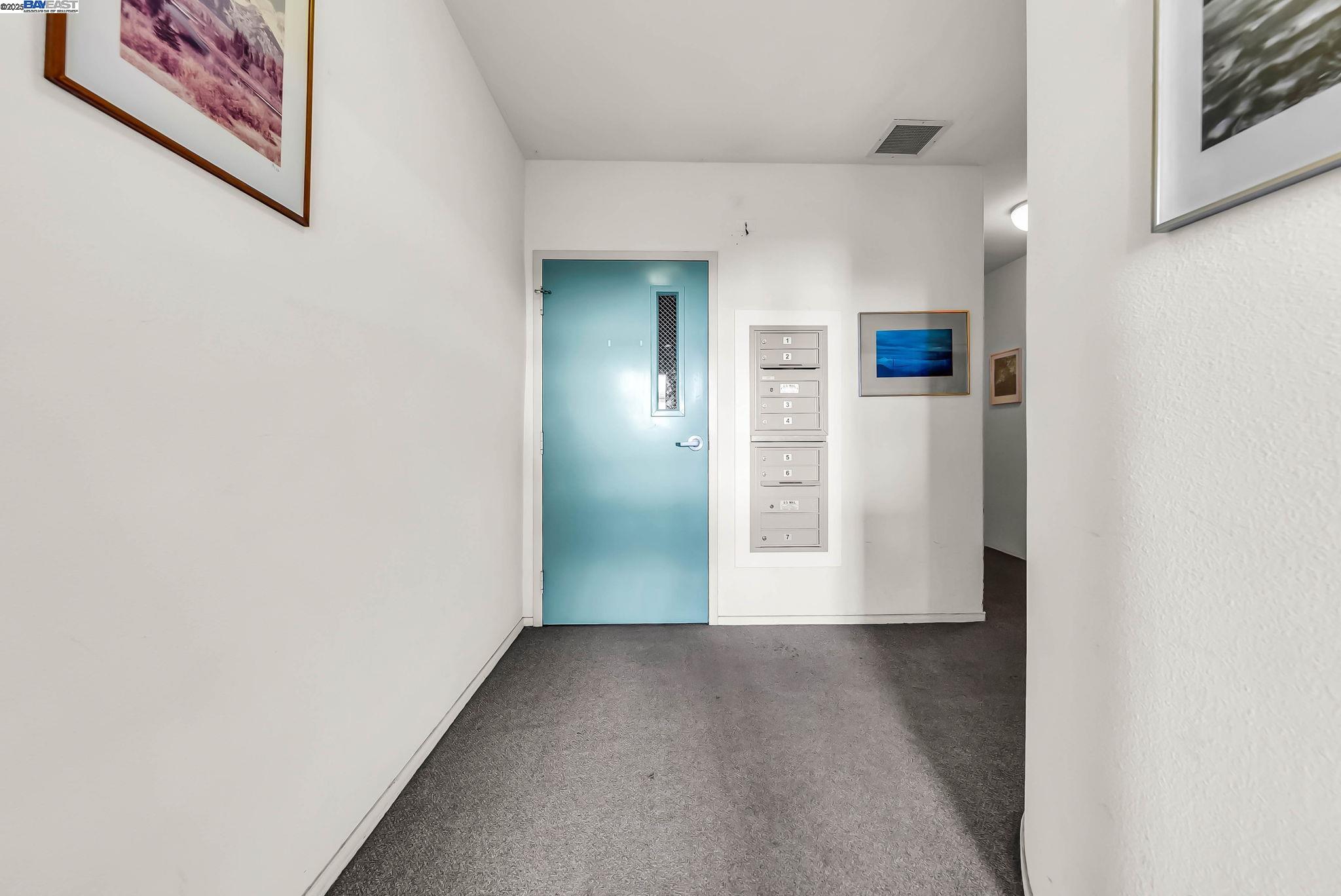 400 Wayne Avenue, Unit 1 Oakland, CA 94606 - Photo 31 of 37 a view of a hallway with wooden floor
