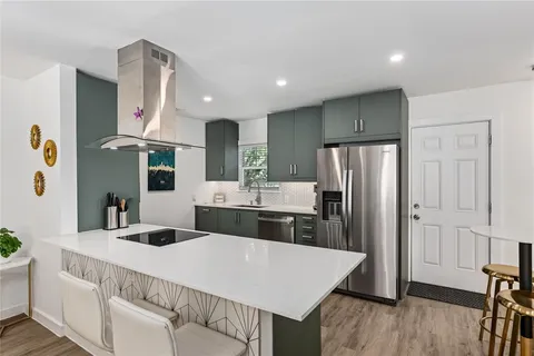 a sink with a mirror and cabinets