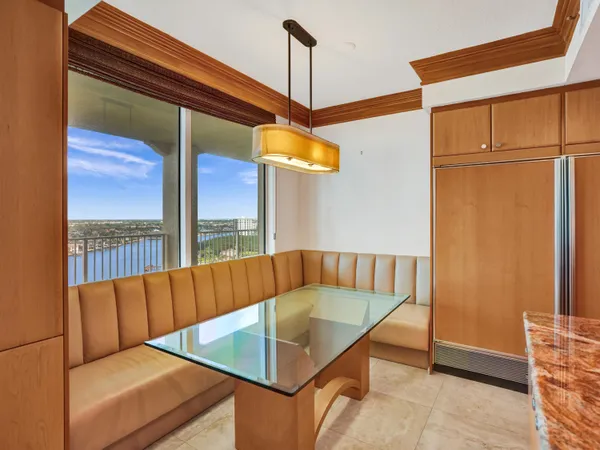 a bedroom with a bed a flat screen tv and a large window