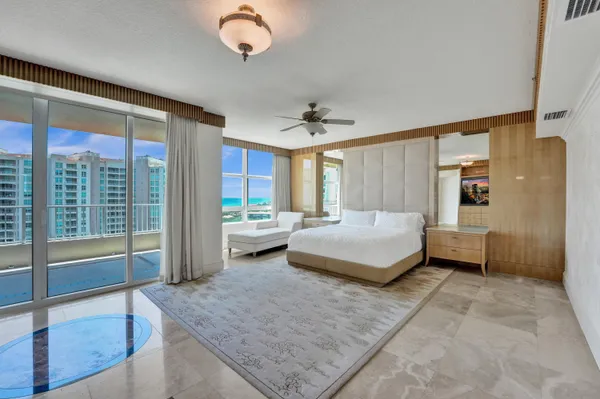 a bedroom with a large bed and a flat tv screen on dresser