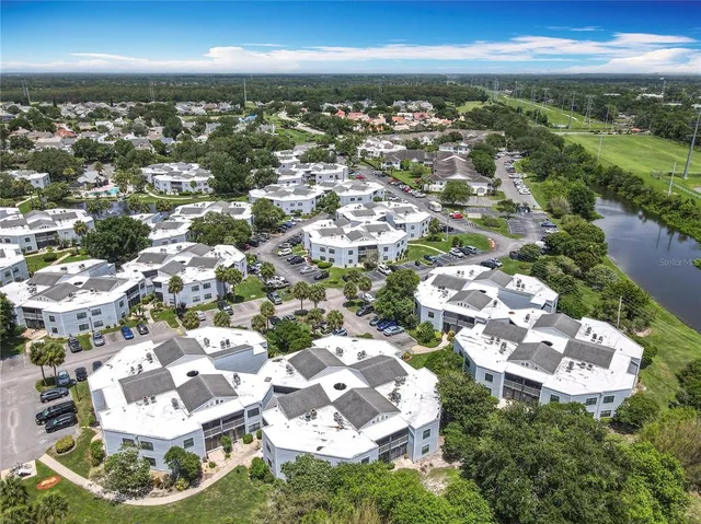 a bathroom with a granite countertop toilet sink and mirror