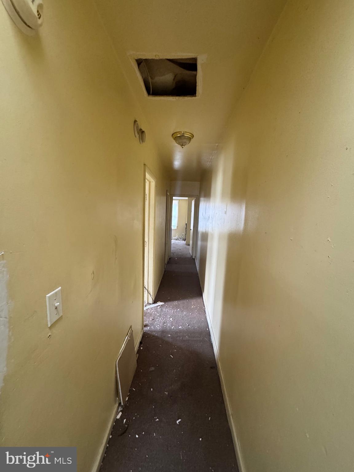 1908 Federal Street Baltimore, MD 21213 - Photo 10 of 18 a view of a hallway with wooden floor and a living room