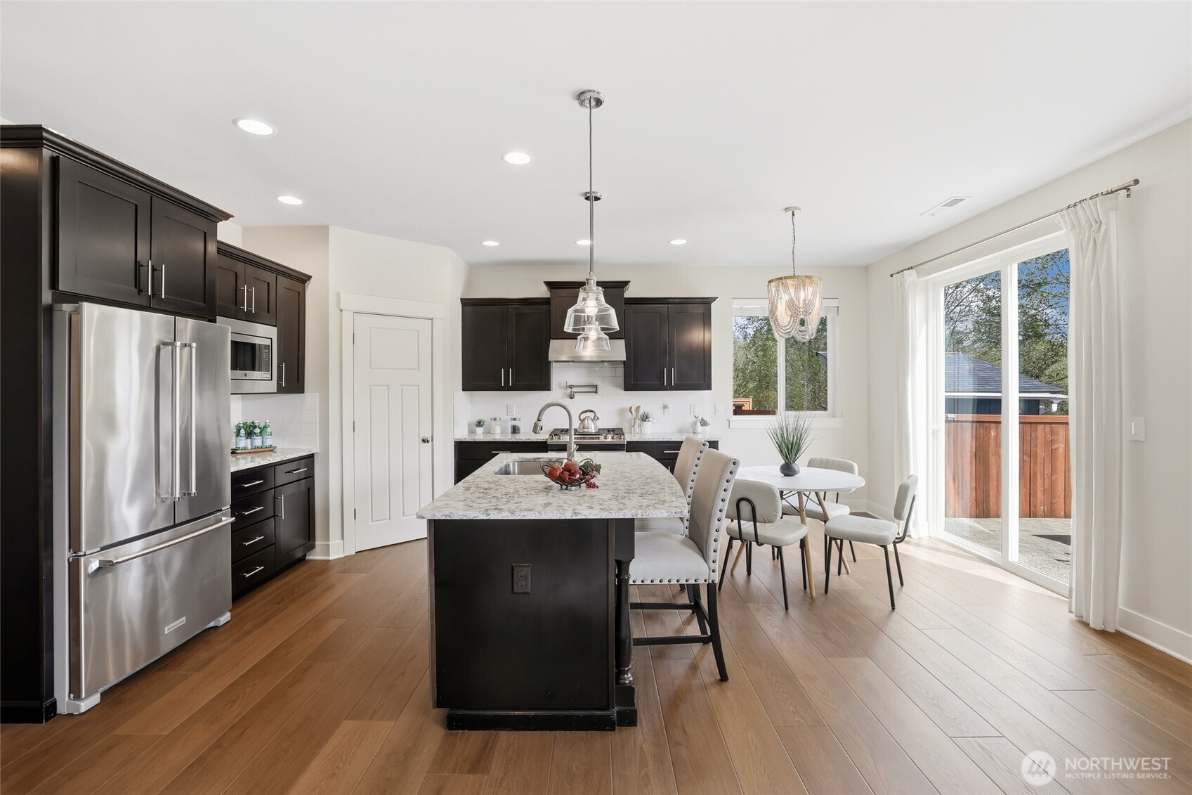 16927 35th Drive Southeast Bothell, WA 98012 - Photo 12 of 38 a large kitchen with a table chairs refrigerator and a sink
