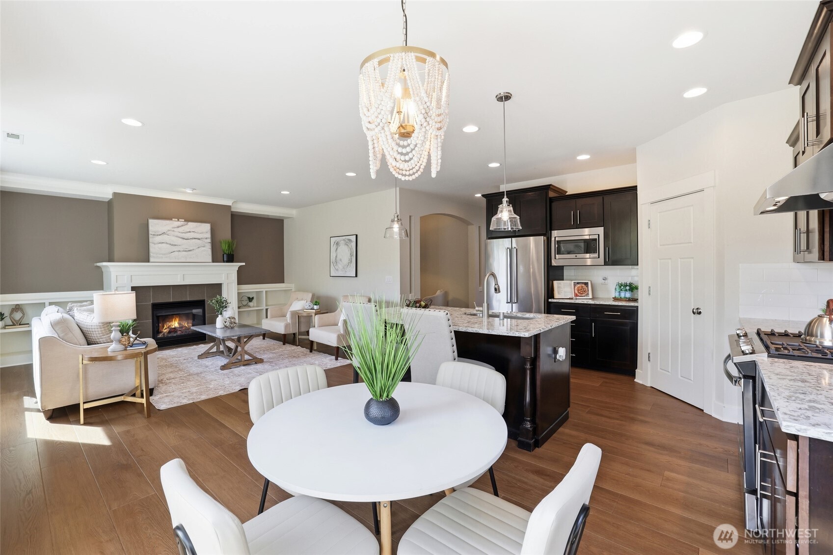 16927 35th Drive Southeast Bothell, WA 98012 - Photo 14 of 38 a view of a dining room with furniture a kitchen and chandelier