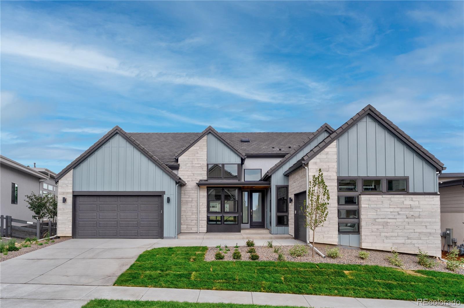 2233 Rim Ridge Drive Castle Pines, CO 80108 - Photo 1 of 40 a front view of a house with garden