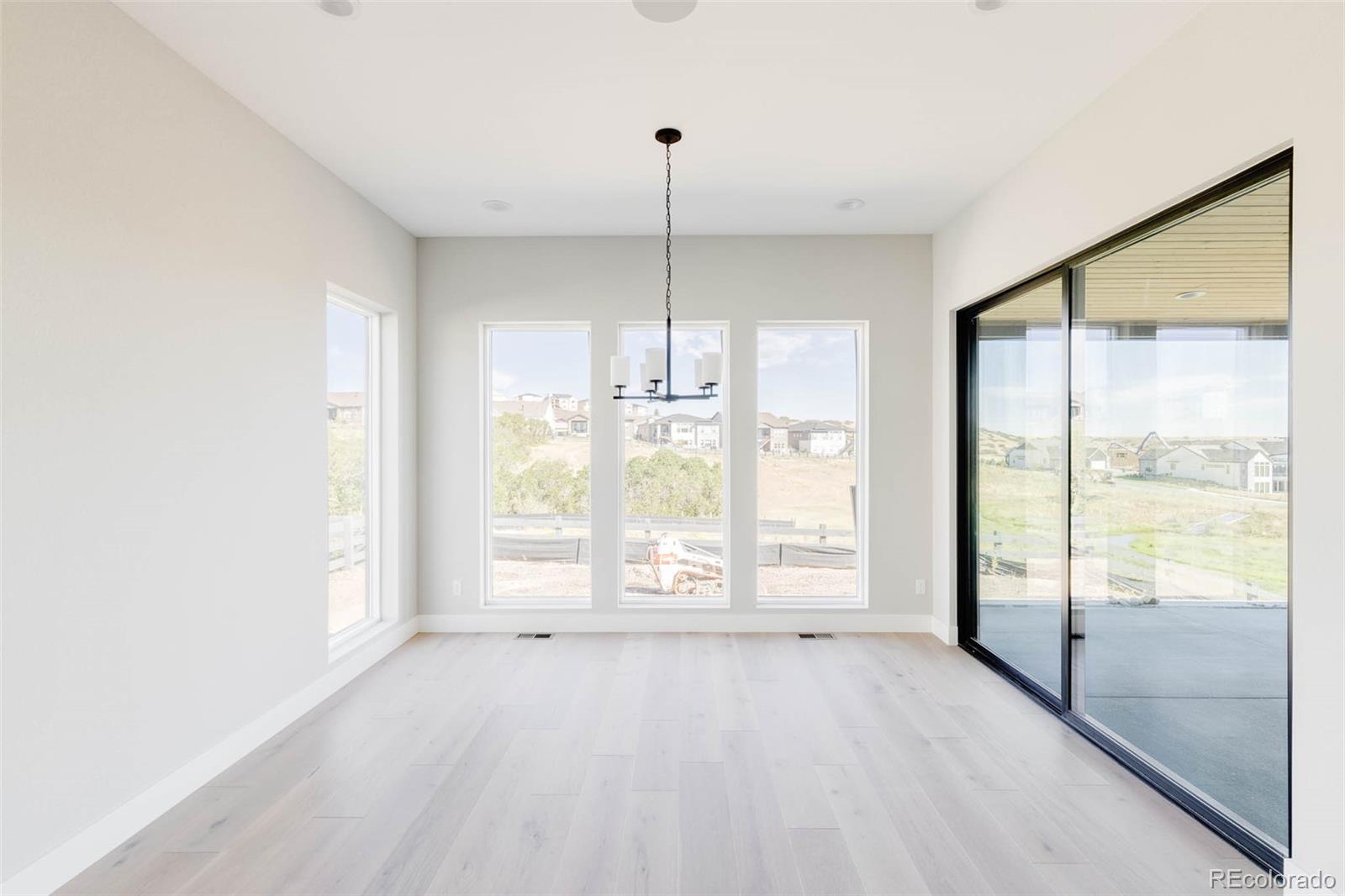 2233 Rim Ridge Drive Castle Pines, CO 80108 - Photo 17 of 40 a view of an empty room with a window