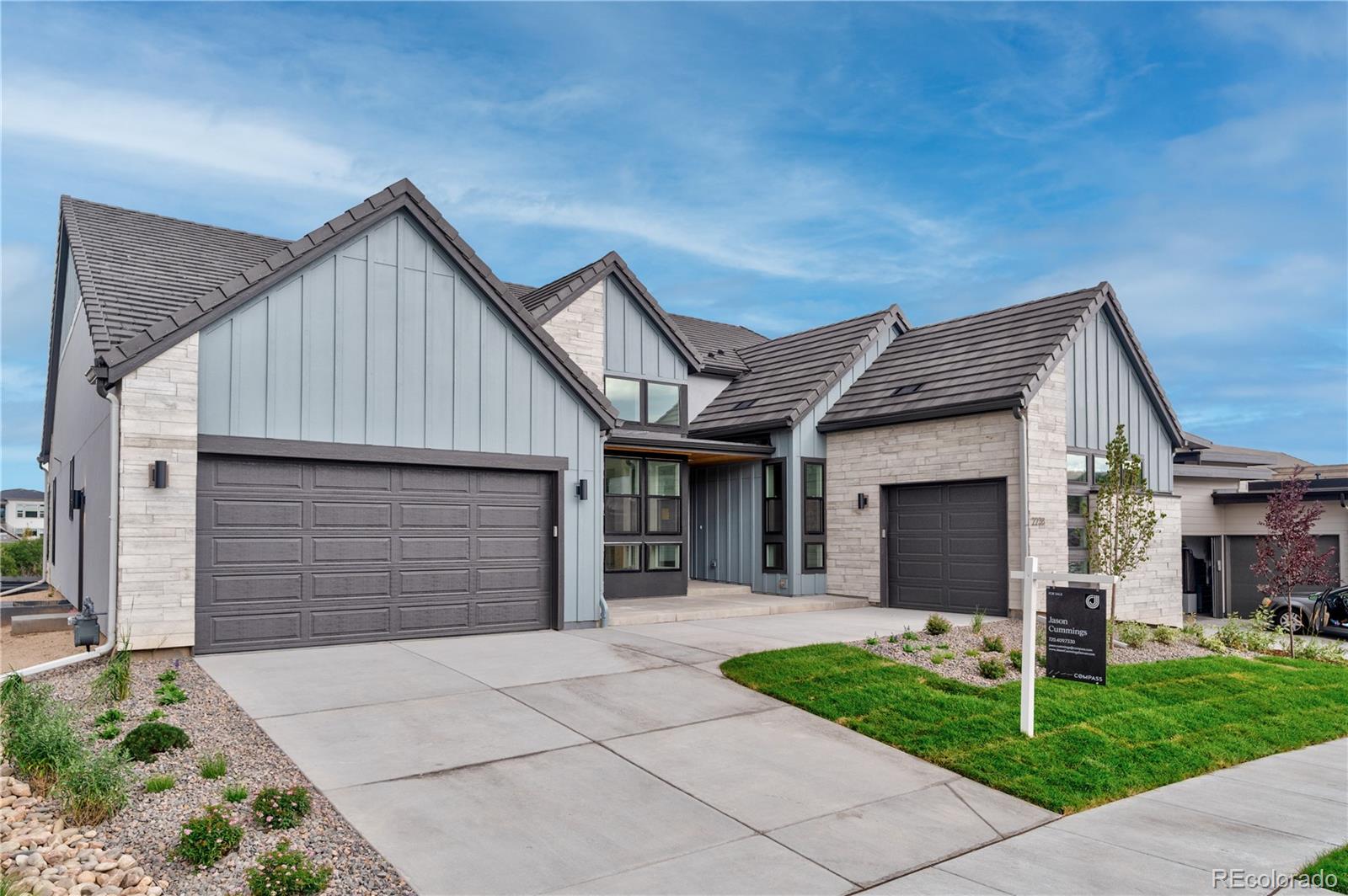 2233 Rim Ridge Drive Castle Pines, CO 80108 - Photo 2 of 40 a front view of house with a garden