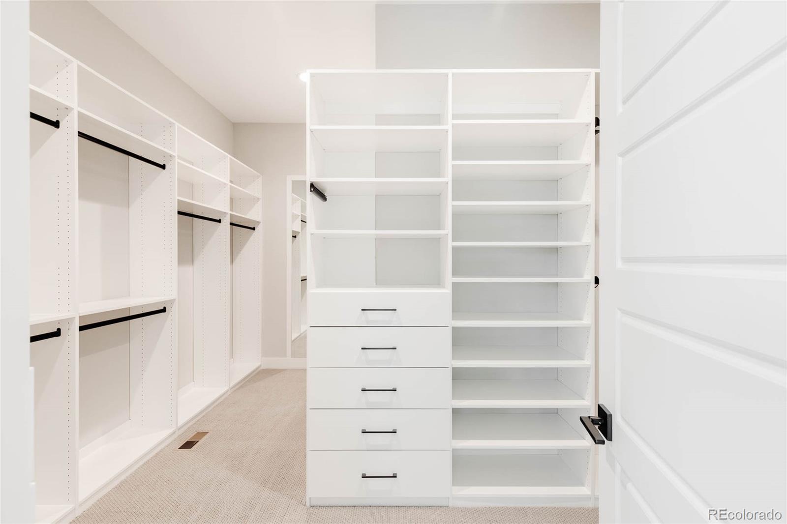 2233 Rim Ridge Drive Castle Pines, CO 80108 - Photo 25 of 40 a view of walk in closet with empty racks