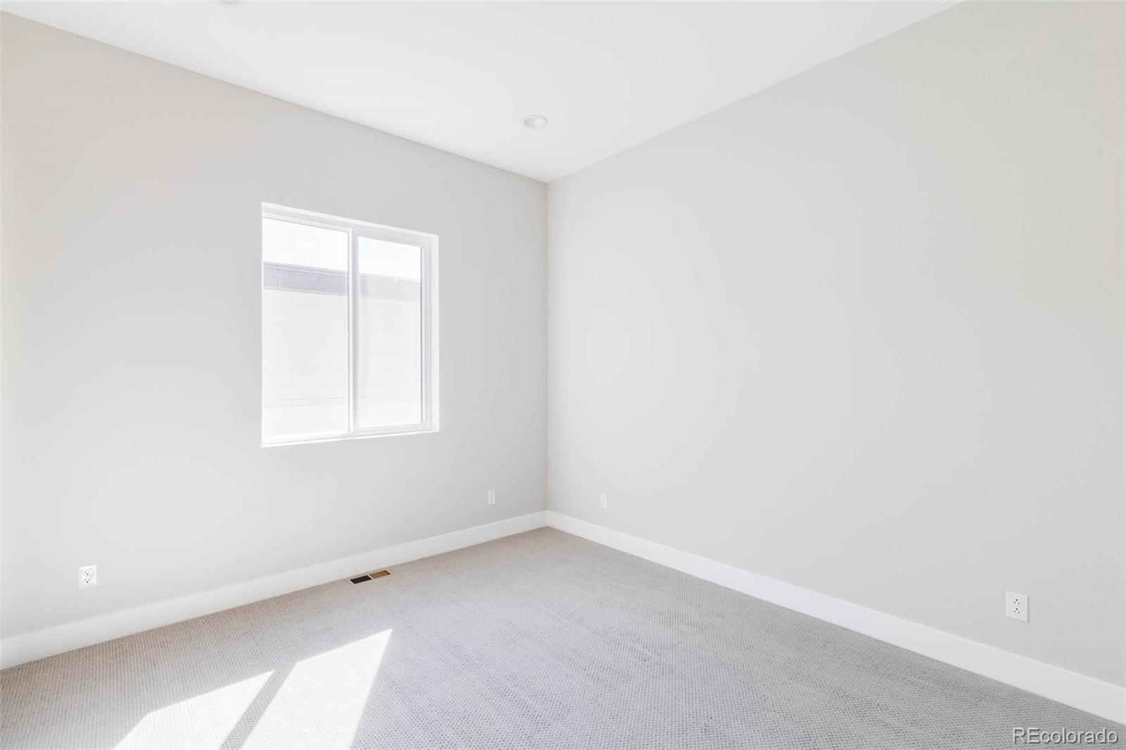 2233 Rim Ridge Drive Castle Pines, CO 80108 - Photo 28 of 40 an empty room with a window