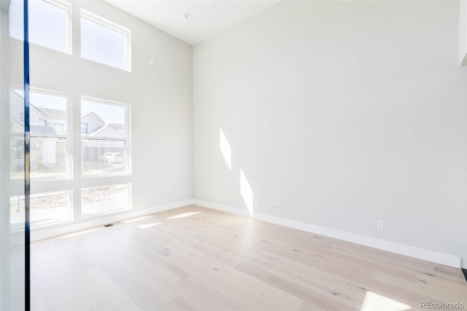 2233 Rim Ridge Drive Castle Pines, CO 80108 - Photo 6 of 40 a view of empty room with wooden floor and fan