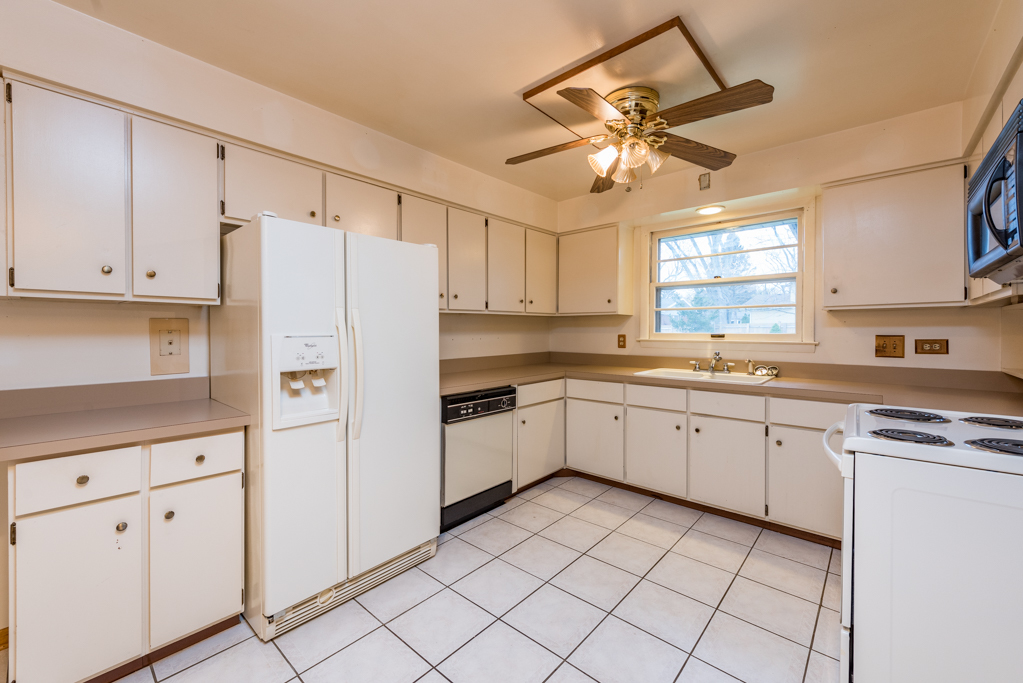 2313 Beck Road Lindenhurst, IL 60046 - Photo 13 of 35 a kitchen with granite countertop cabinets and white stainless steel appliances