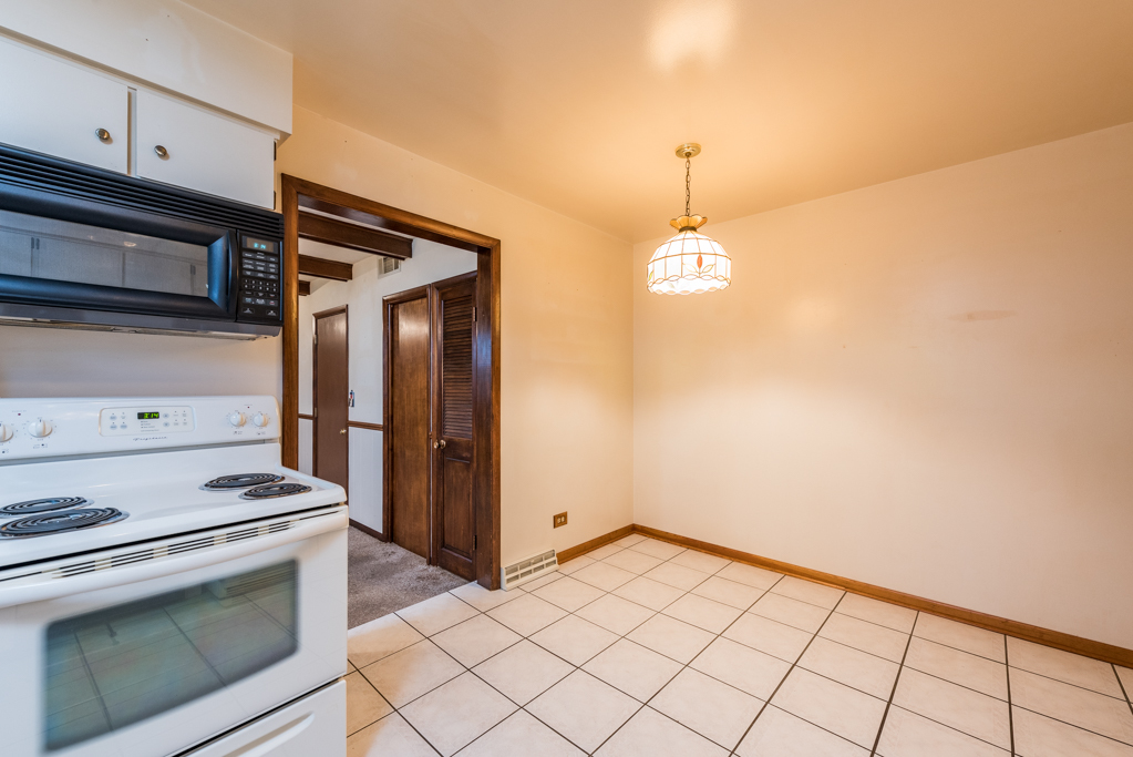 2313 Beck Road Lindenhurst, IL 60046 - Photo 14 of 35 a kitchen with white cabinets and white appliances