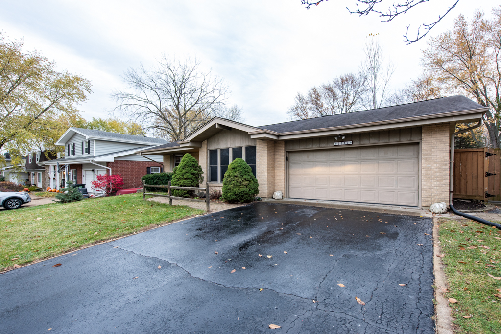 2313 Beck Road Lindenhurst, IL 60046 - Photo 3 of 35 a front view of a house with a yard and garage