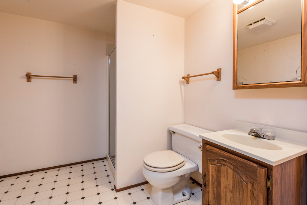2313 Beck Road Lindenhurst, IL 60046 - Photo 26 of 35 a bathroom with a sink a toilet and a mirror
