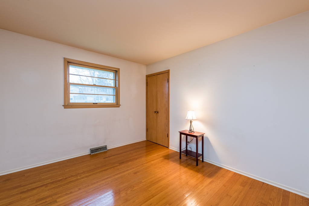 2313 Beck Road Lindenhurst, IL 60046 - Photo 9 of 35 a view of an empty room with wooden floor and a window
