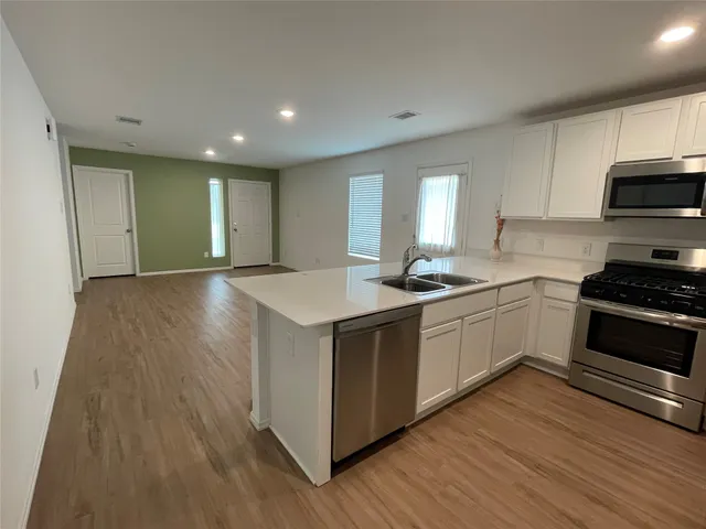 a kitchen with granite countertop a stove and a sink