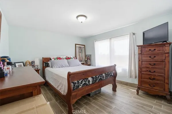 a bed room with a bed and a television