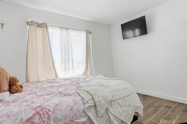 a bedroom with a bed and a tv
