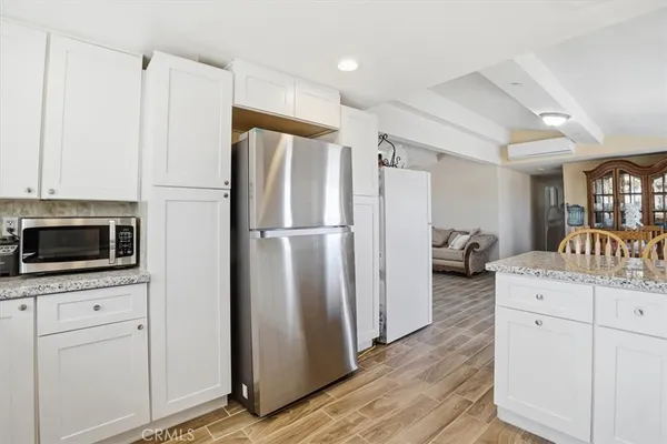 a kitchen with appliances a counter space and cabinets